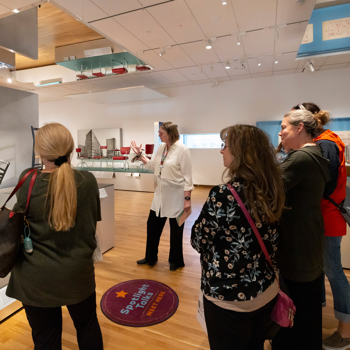 Docent giving a tour to a large group of women