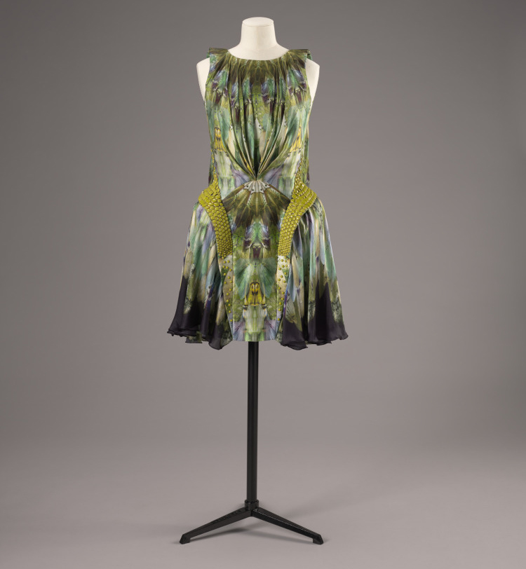 Green fashionable dress on a mannequin stand