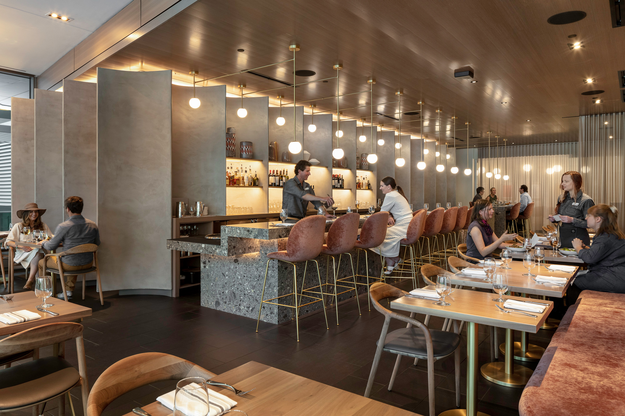 Interior view of The Ponti restaurant, with guests dining at the table and at the bar