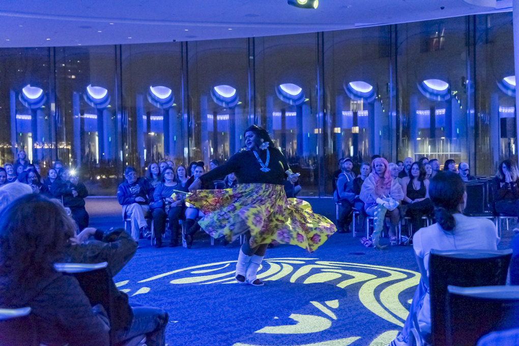 Guests gathered around a dance performer in the Sie Welcome Center
