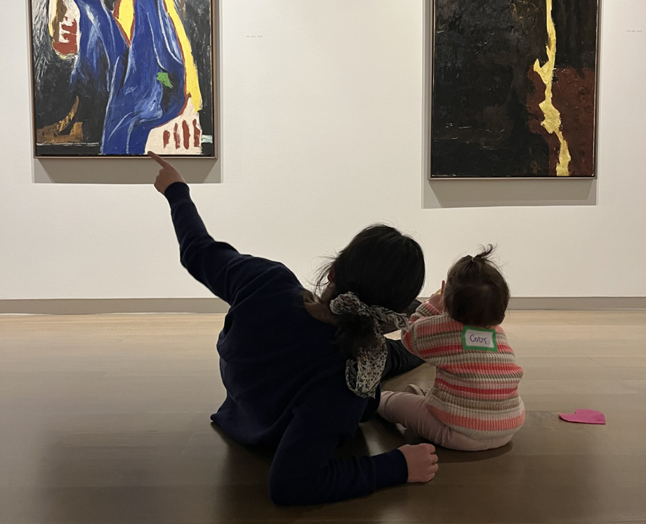 Woman explaining a painting to a young child