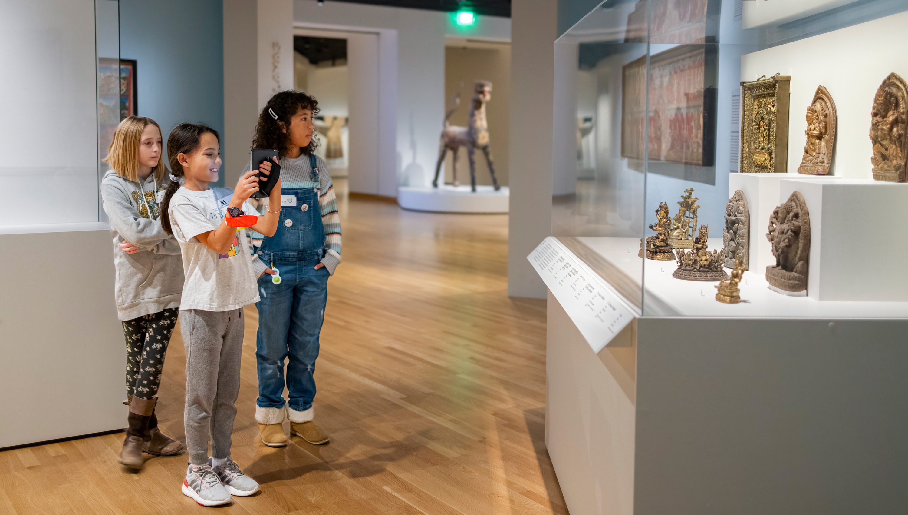 three girls in one of the Asian art galleries at the DAM