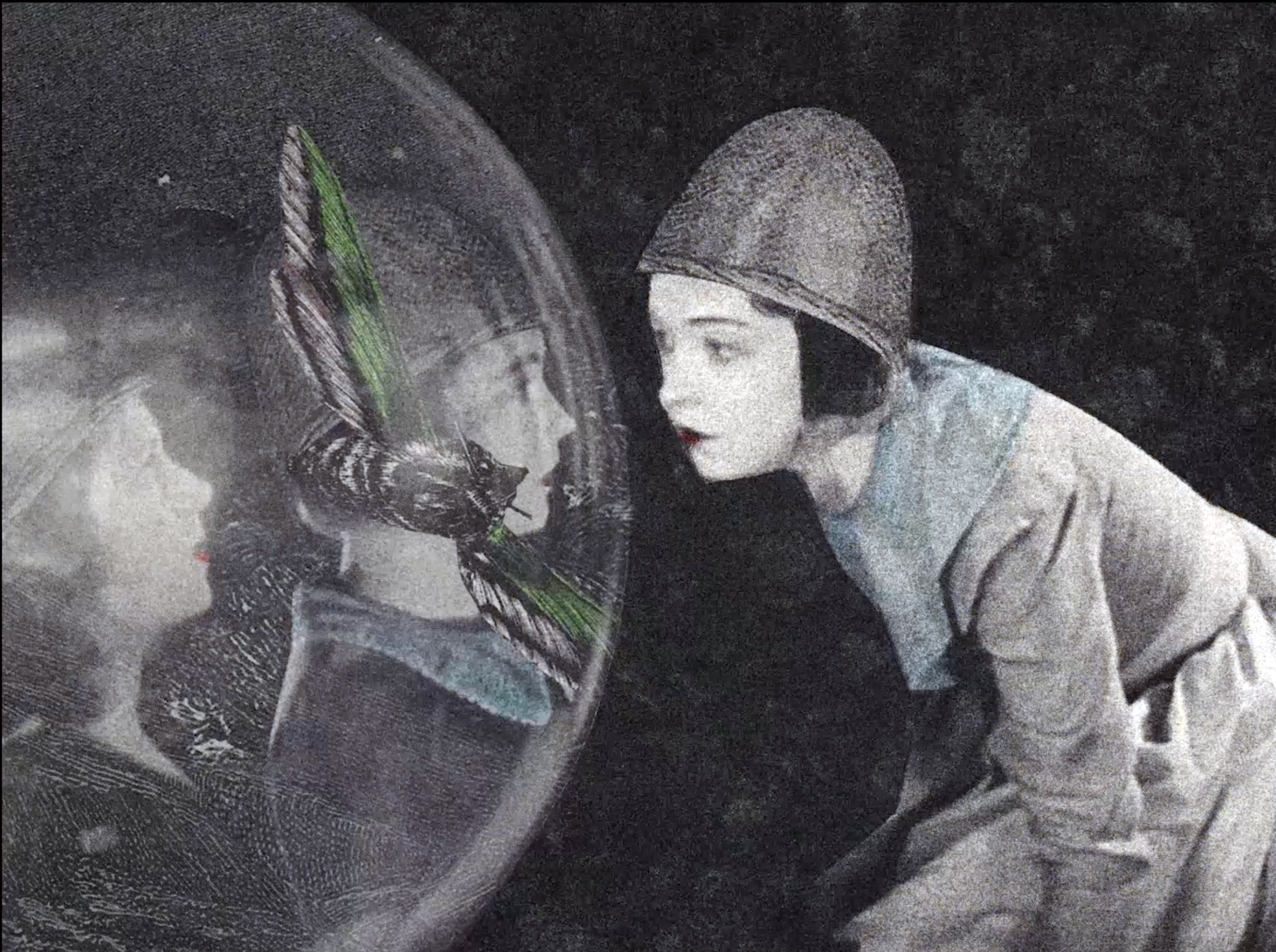 Black and white image of a woman looking into a spherical mirror