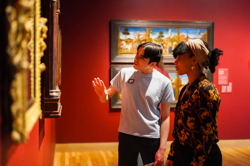 Two guests examining a painting