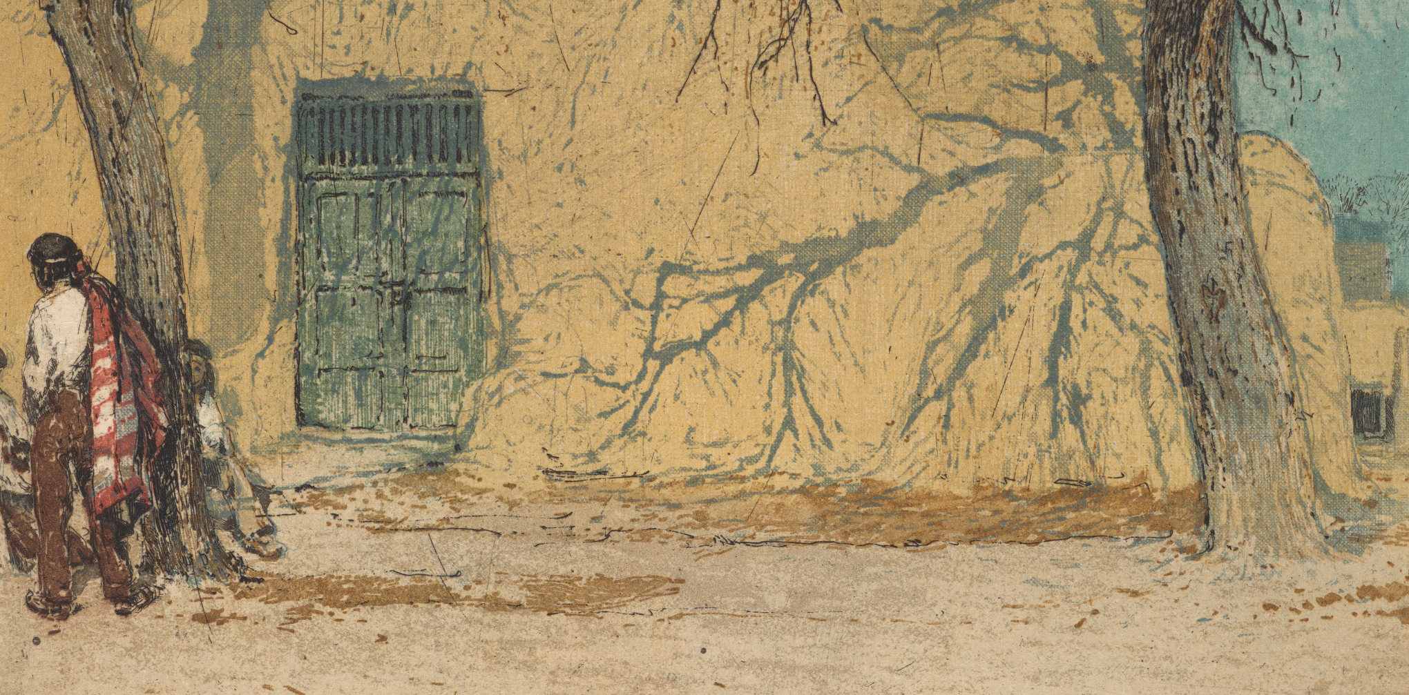 Man walking past a pueblo-style building and tree in Sante Fe, New Mexico
