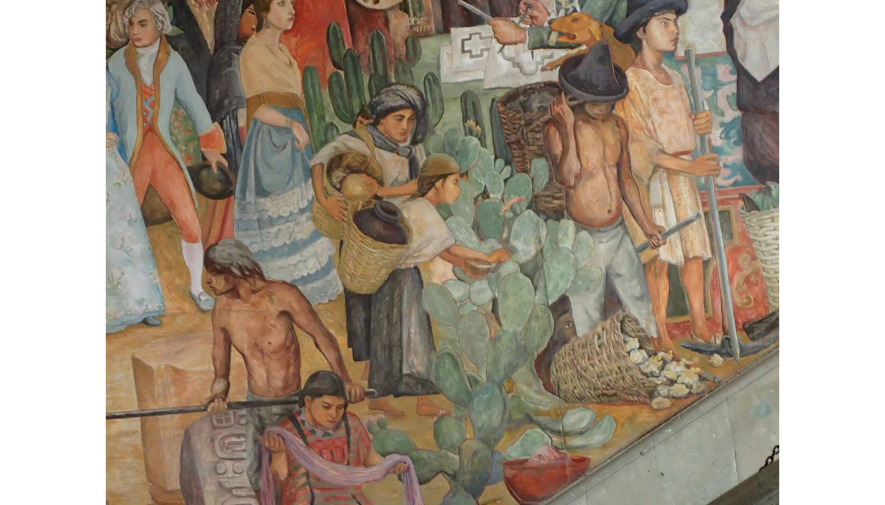 Large crowd gathered in a town square selling various items