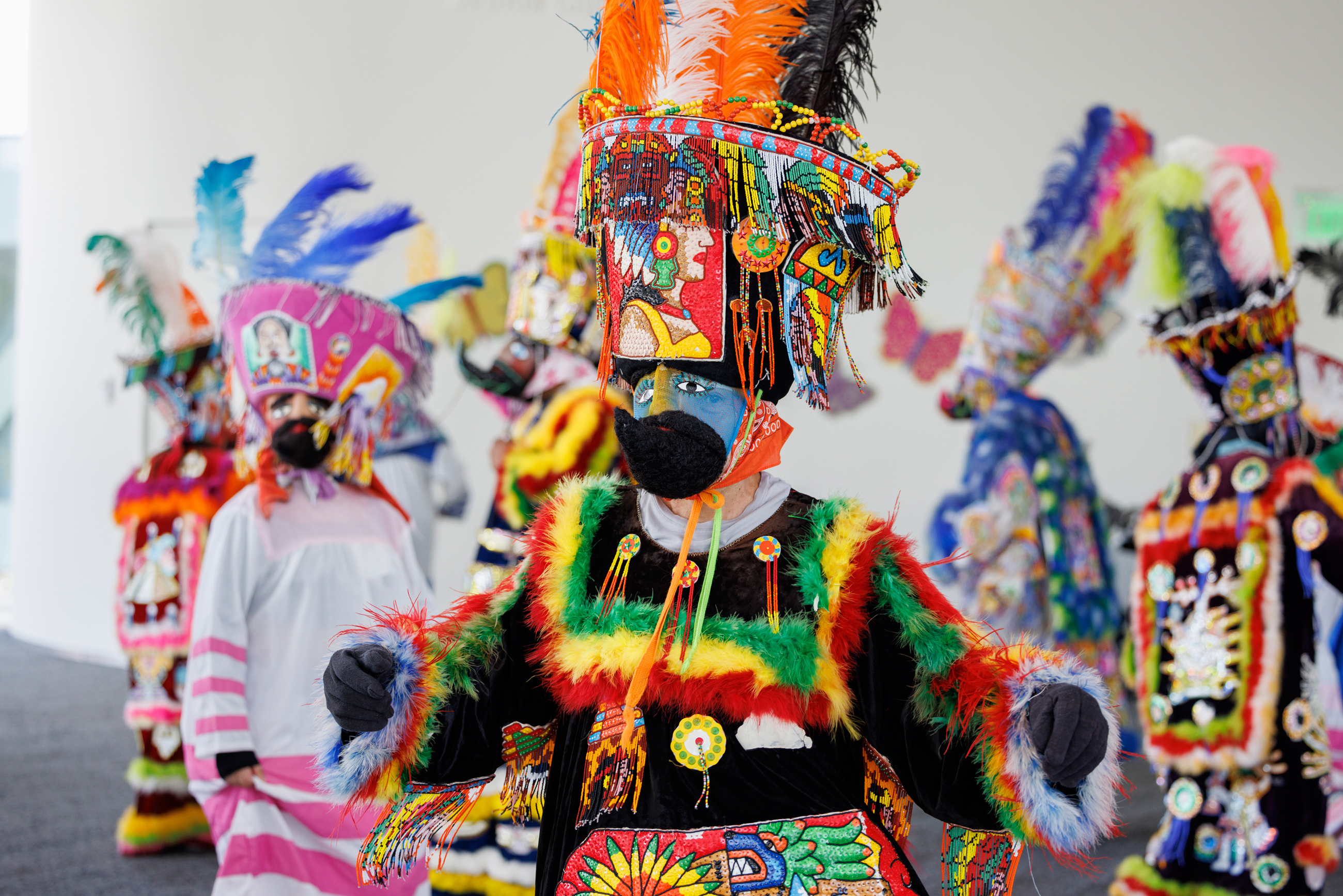 Performer in colorful Indigenous costume dancing for Dia del Nino