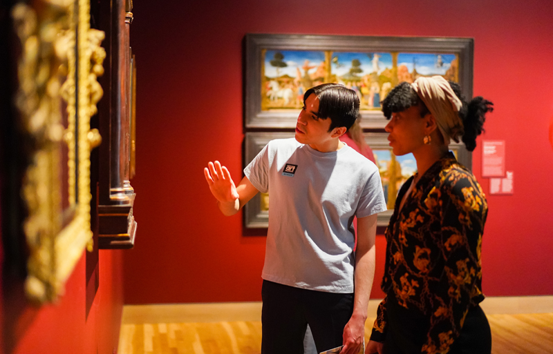 Two guests examining a painting