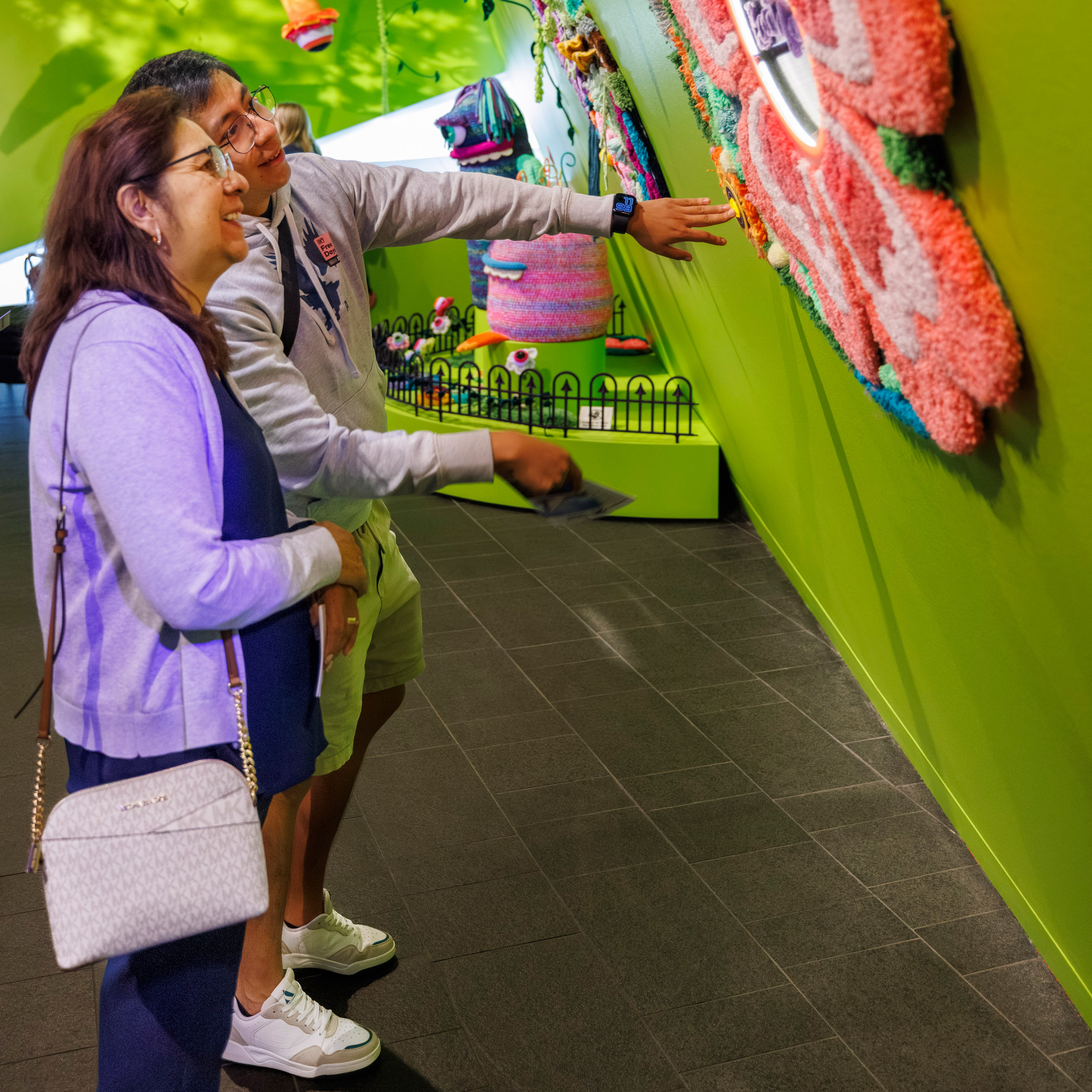 Older woman and man enjoying a colorful artwork