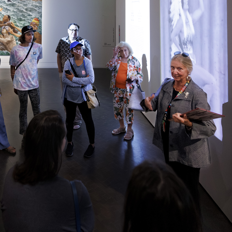 Woman giving a tour to a large group of visitors