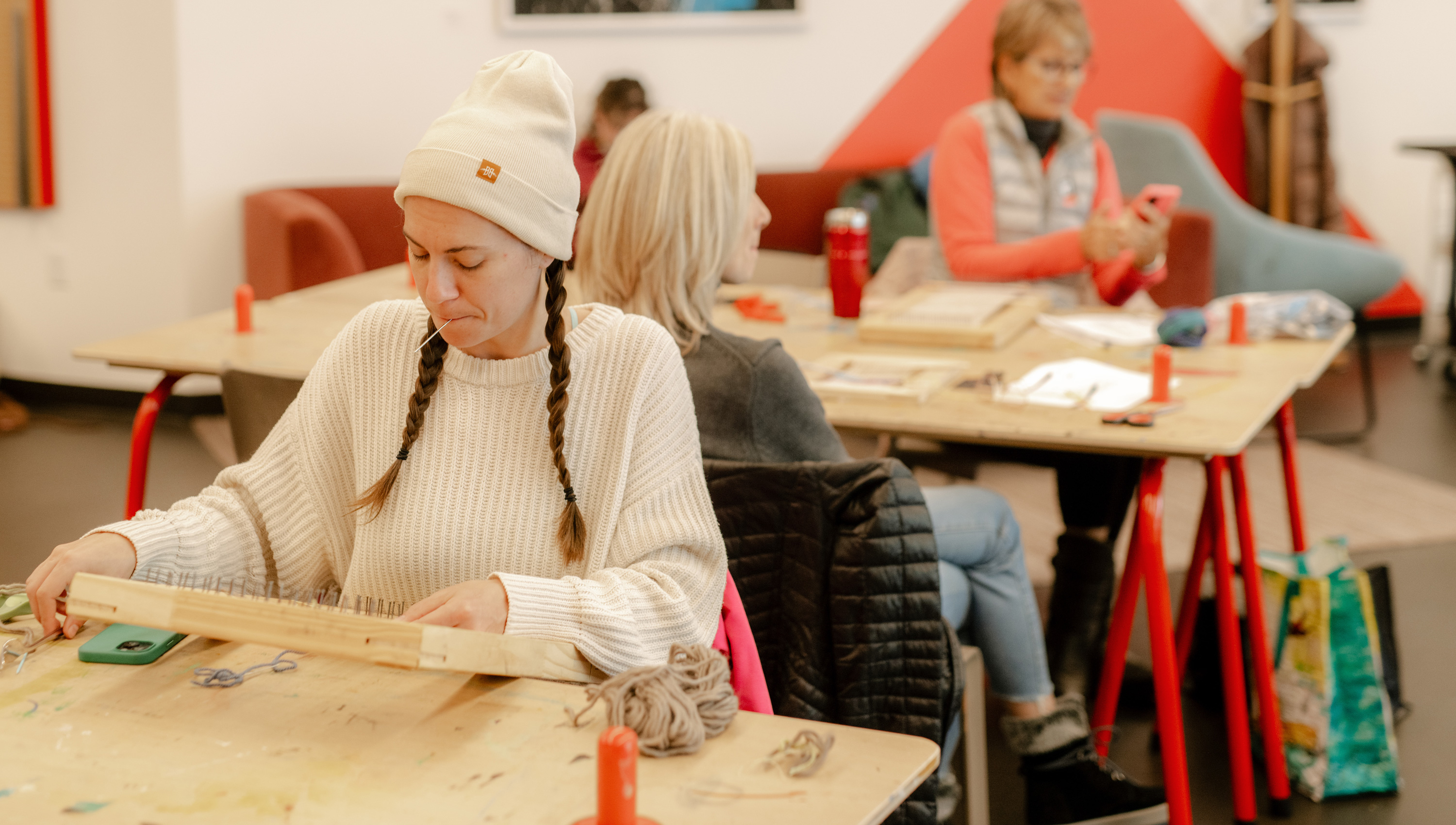 women working on art projects at tables in the museum