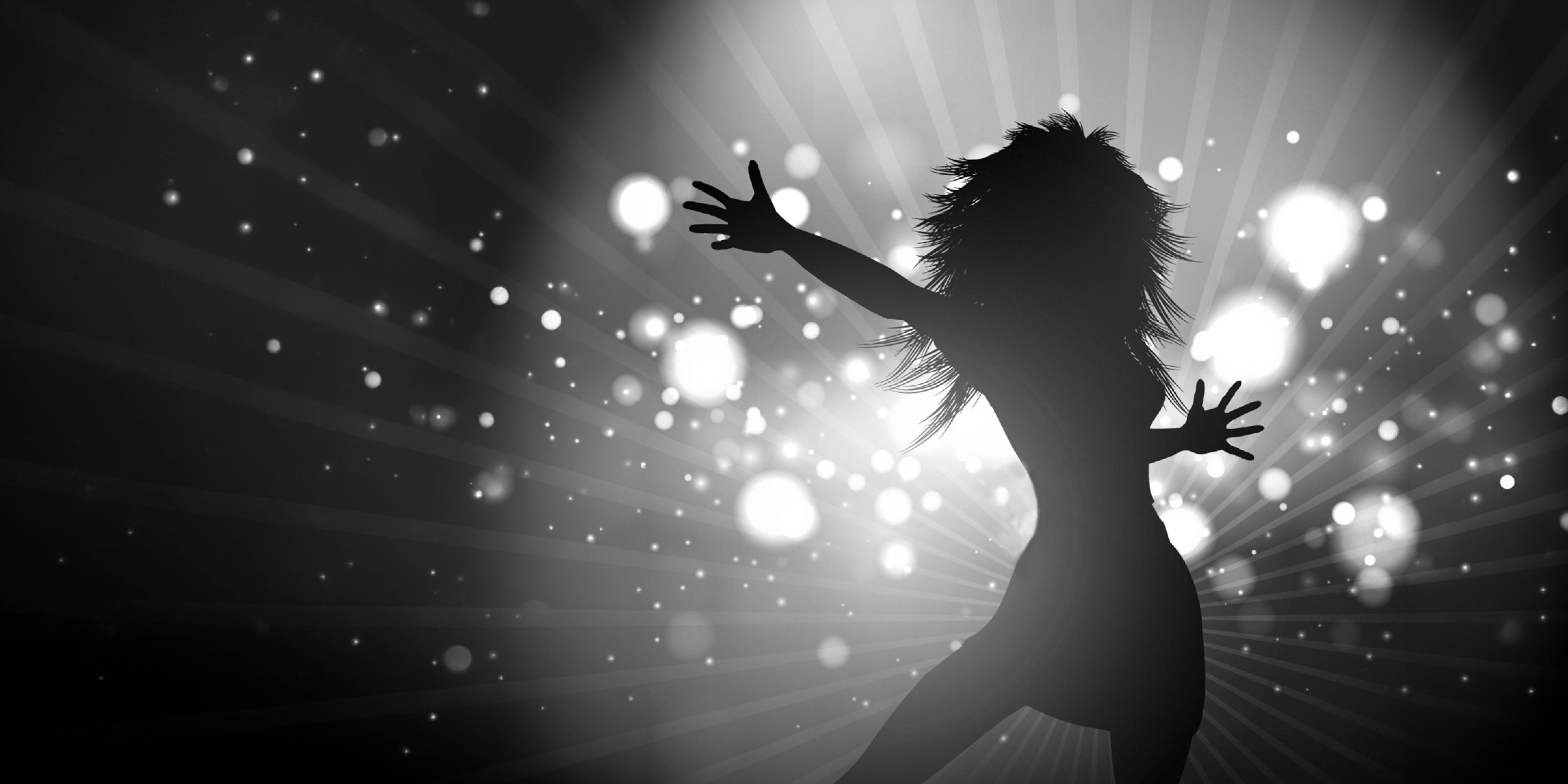 Black and white silhouette of a female singer under stage lights
