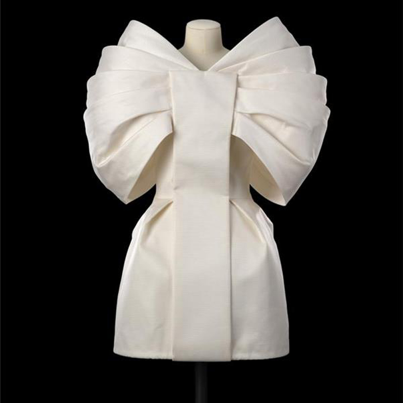 White dress on a mannequin against a black background