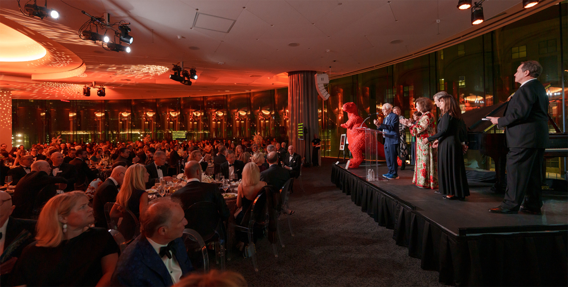 Large crowd gathered from a fundraising event in the Denver Art Museum's Sturm Grand Pavilion