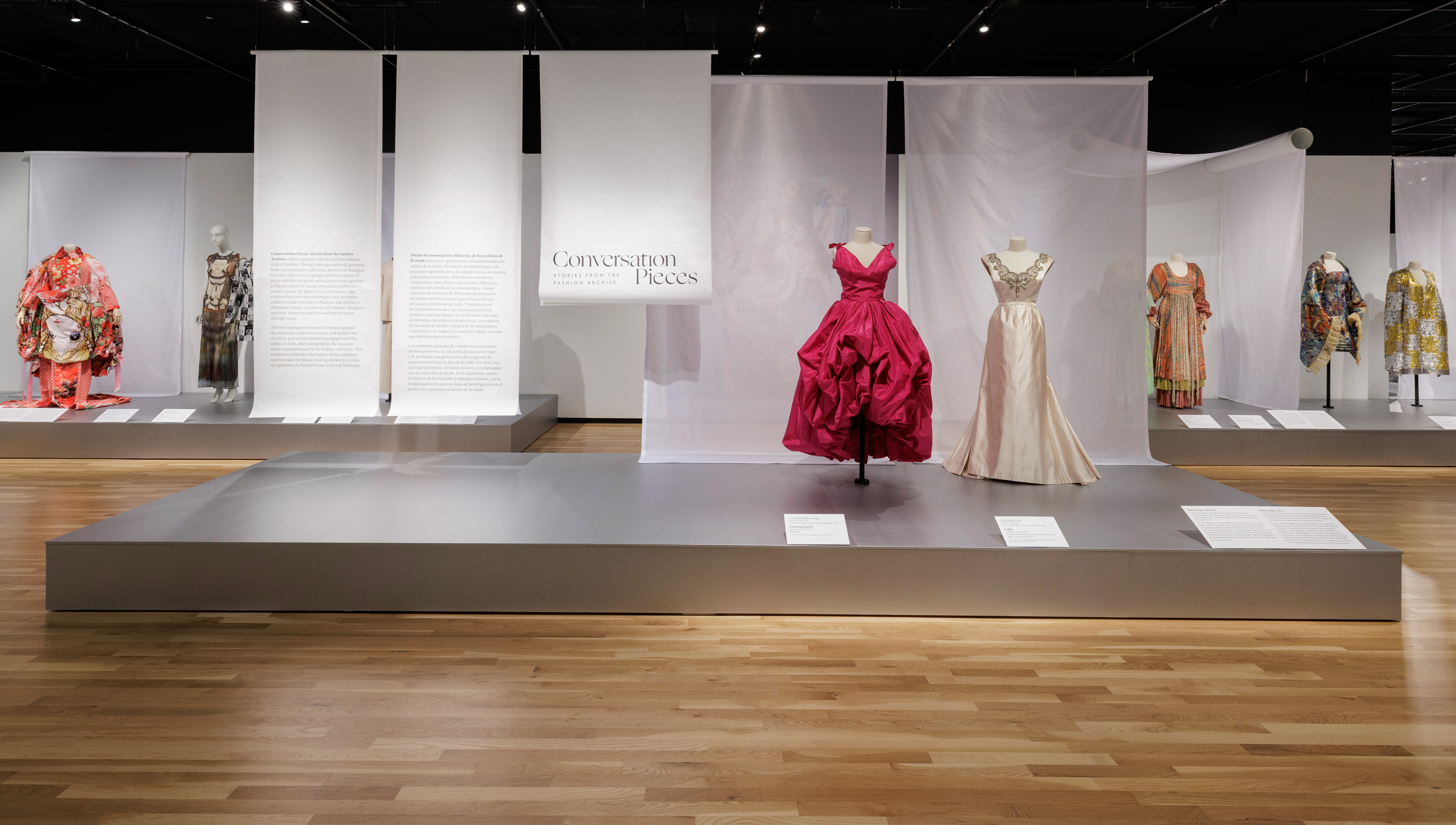 dresses displayed on platforms in the Conversation Pieces exhibition