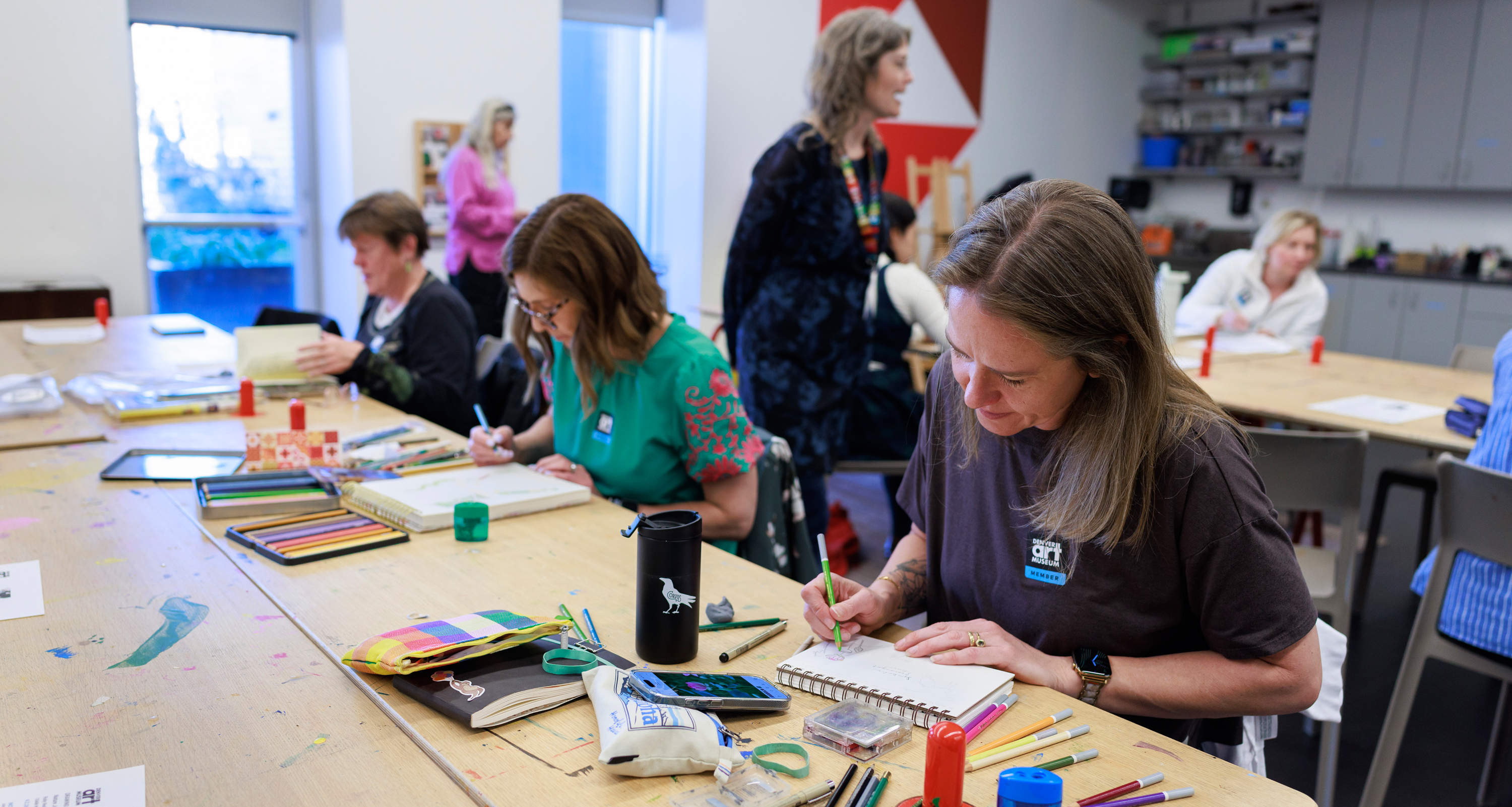 Women taking an artmaking class in a classrom environment