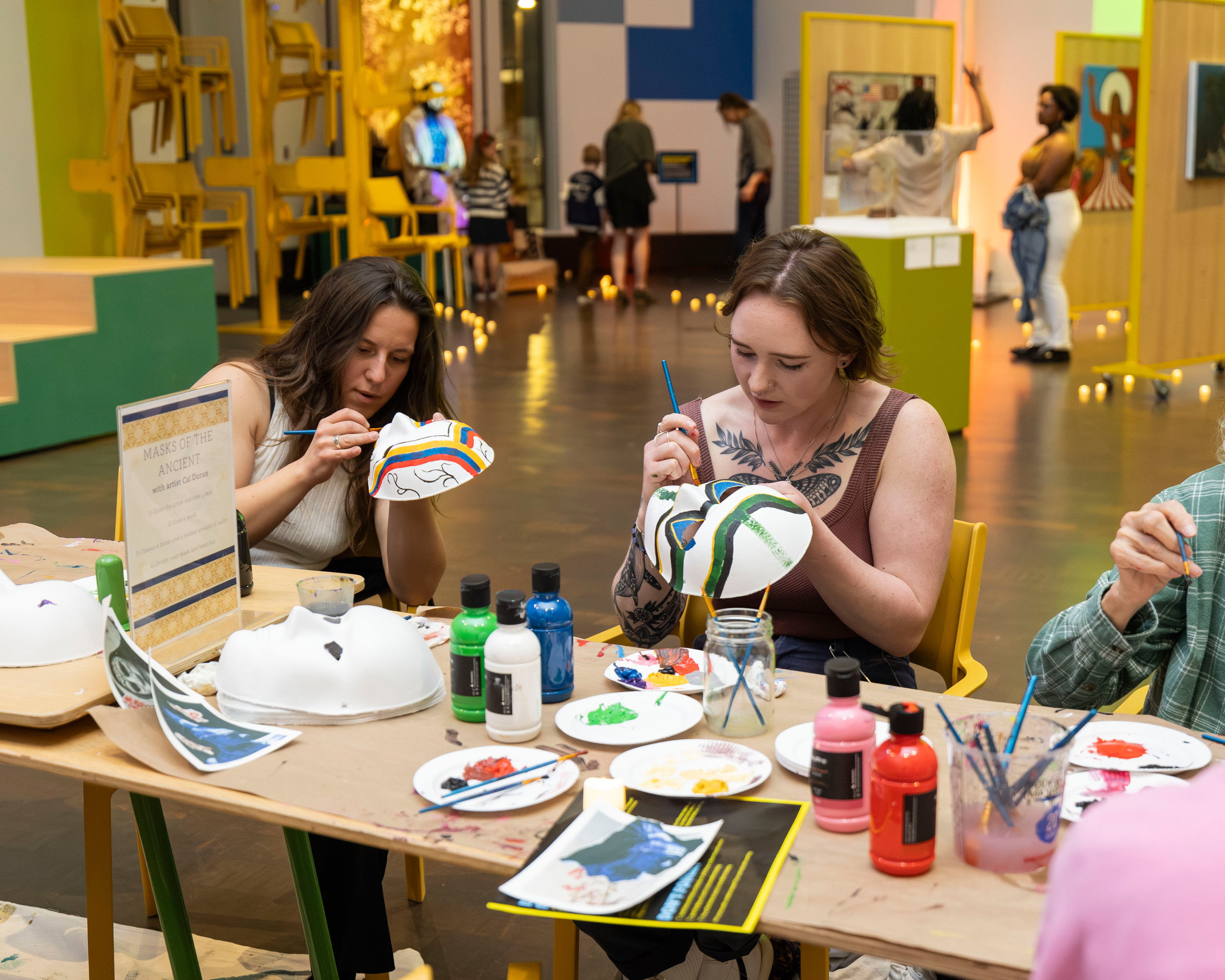 Two women at a table making arts and crafts