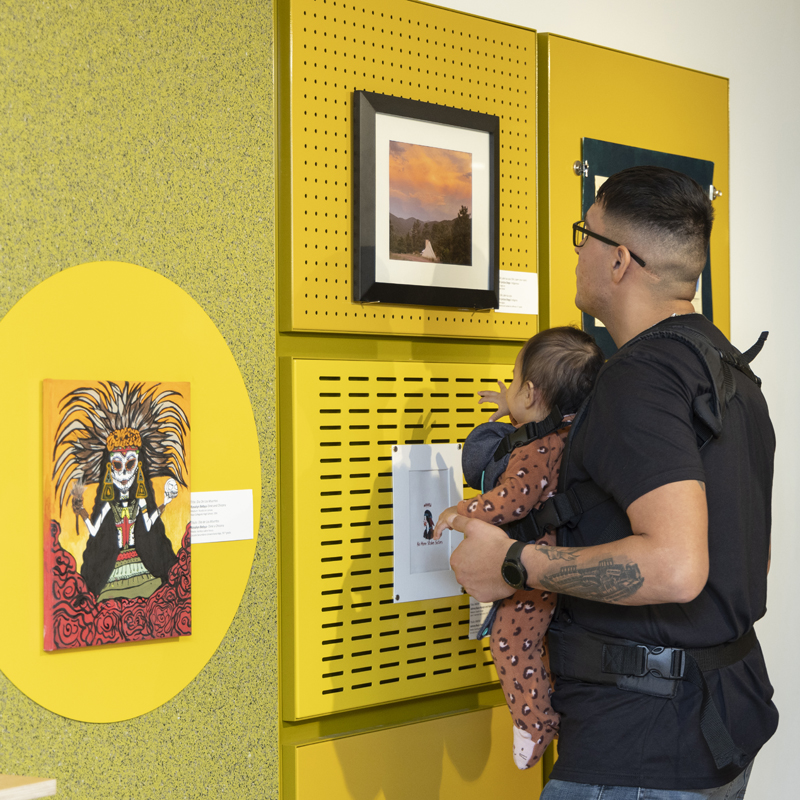 Father and young child looking at art in the Wonderscape