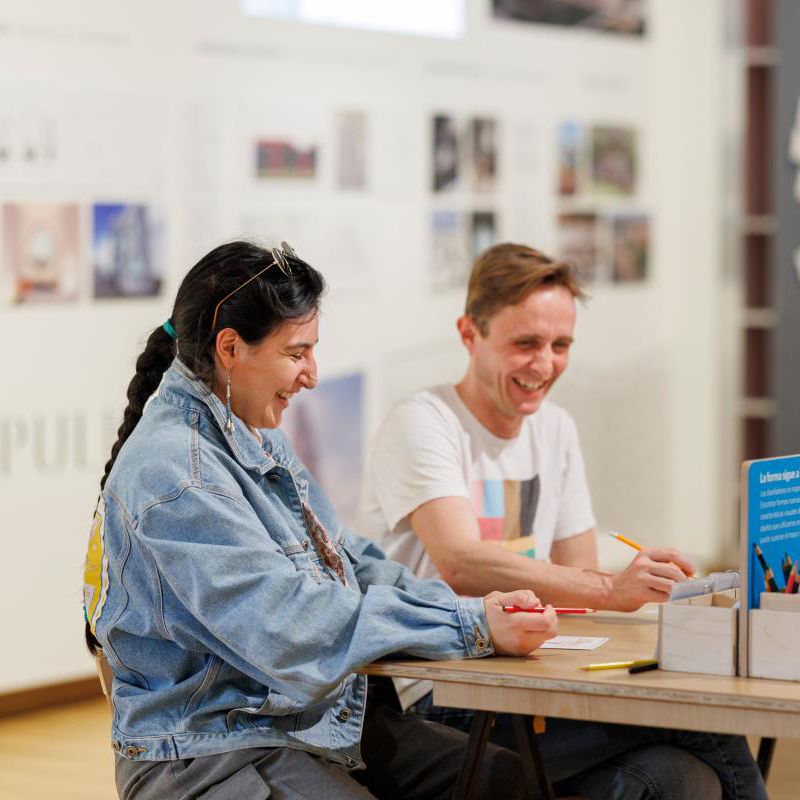 Two visitors sitting and creating in the Design Studio