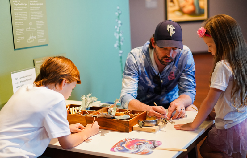 Father and his son and daughter making art together