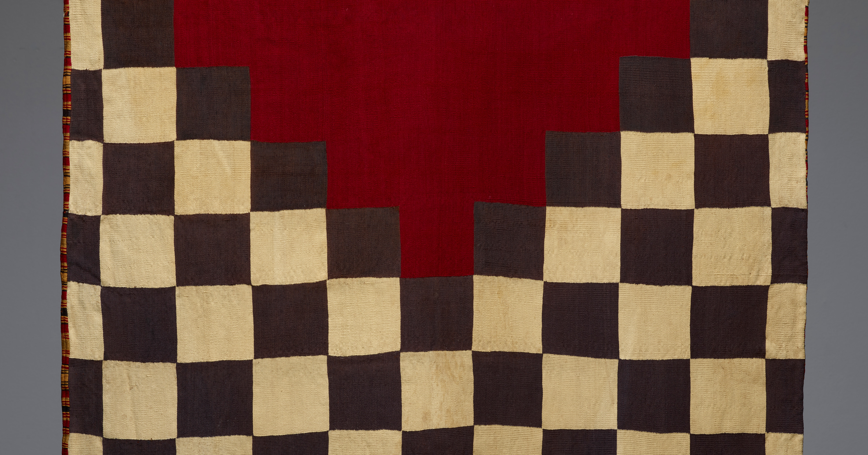 Checkered-patterned textile with bright red ends