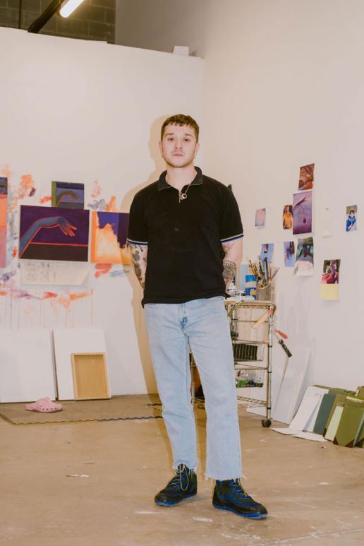Caleb Hahne standing in his art studio