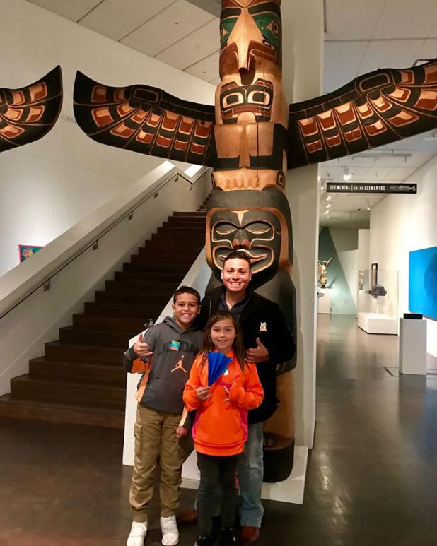 a man and two children in the Stampede exhibition