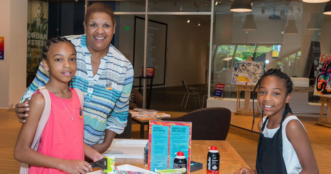 a woman and two children in the paint studio