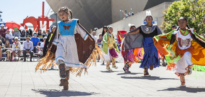 Young female American Indian dancers in front of the art museum