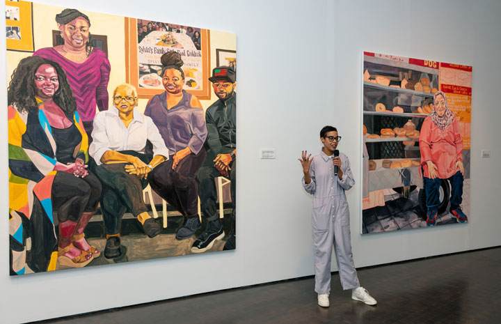 Jordan Casteel speaking next to her two paintings at the media preview for her exhibition