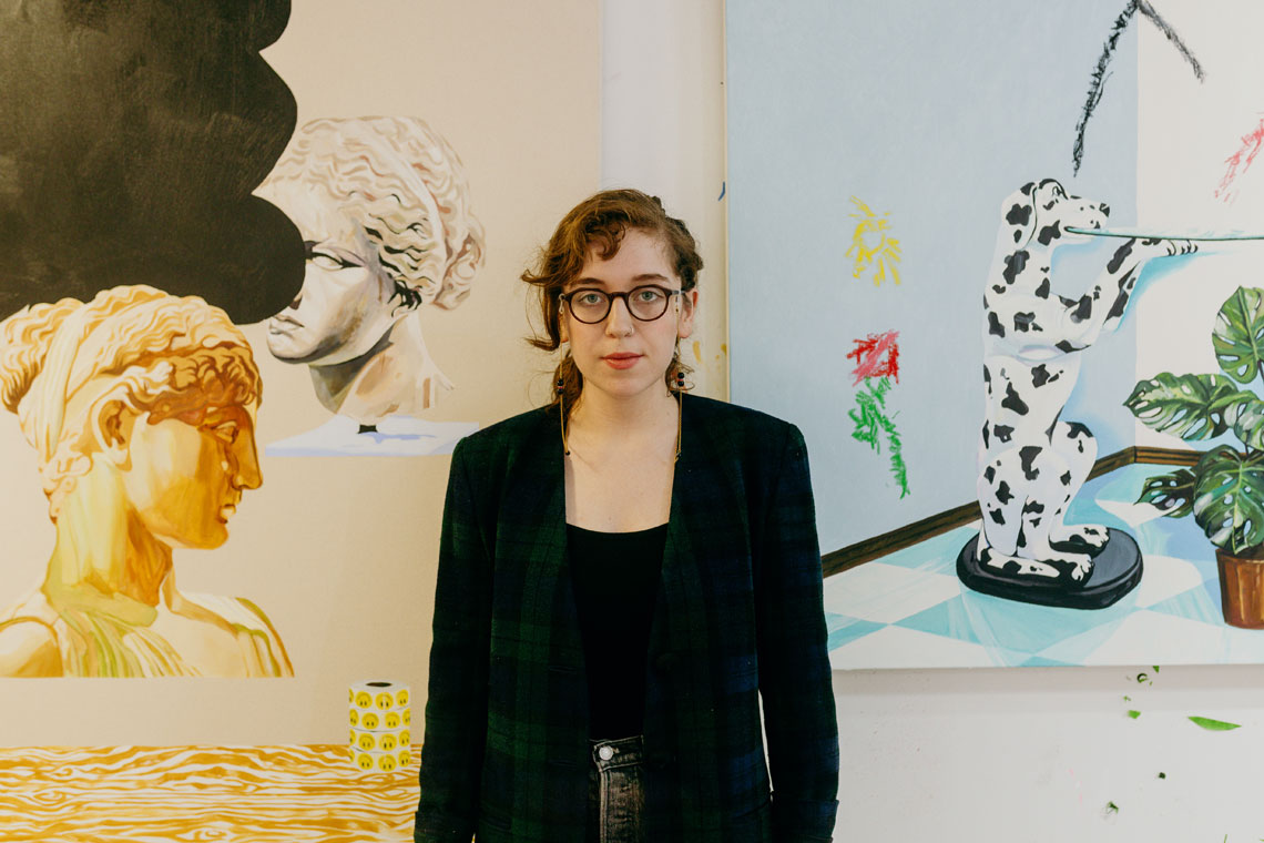 Sierra Montoya Barela in front of one of her artworks