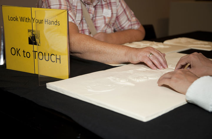 People touching tactile table
