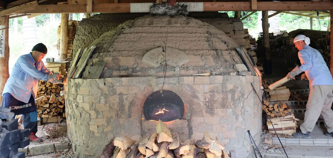 two men firing kiln