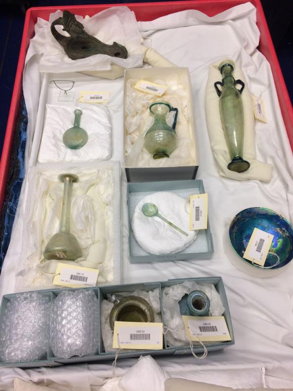 ancient glass items in a box