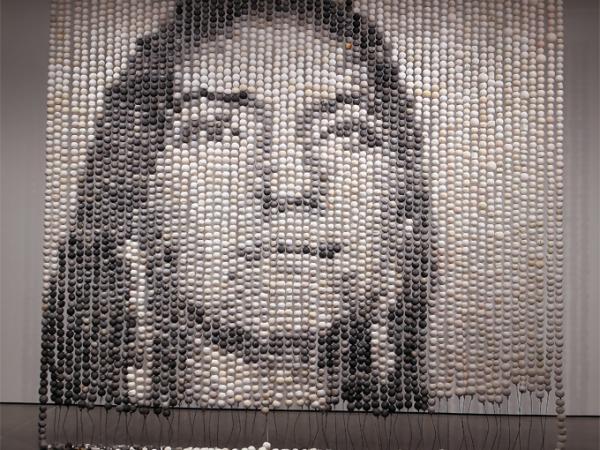 Large beaded installation that shows the image of a face