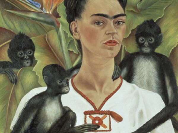 Frida Kahlo from the waist up with a monkey sitting on her arm