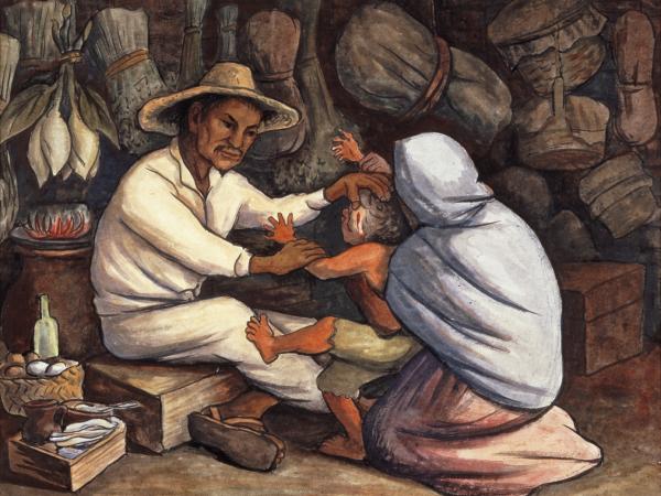 A woman holding her outstretched child in front of a man dressed in all white