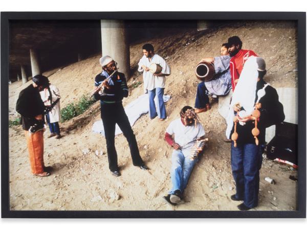 A band and their instruments hanging out under an overhead pass