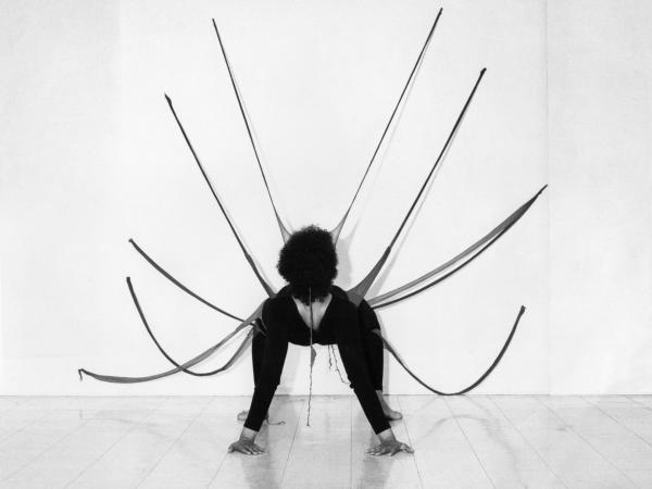 A woman on all fours facing away from the camera