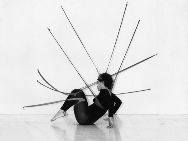A woman striking a dancer's pose on the ground