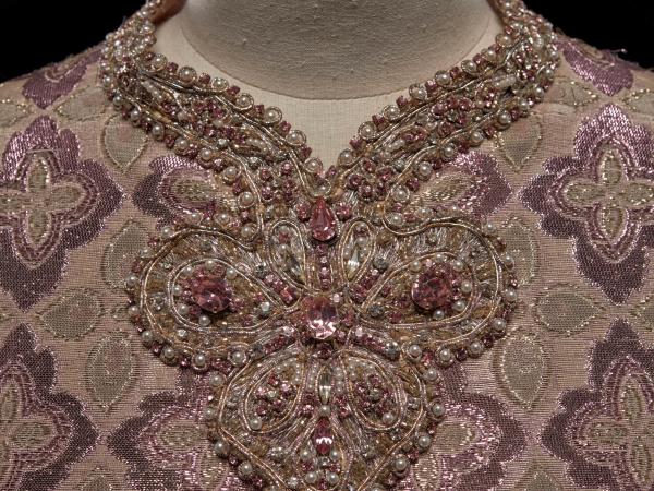 Close-up look at the intricate beading along a dress's neckline