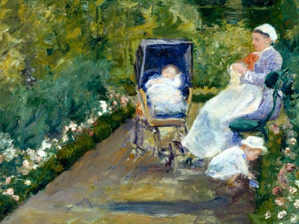A woman sitting on a park bench with her child in a stroller nearby.
