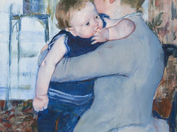 A woman facing to the side with her child wrapped in her arms.