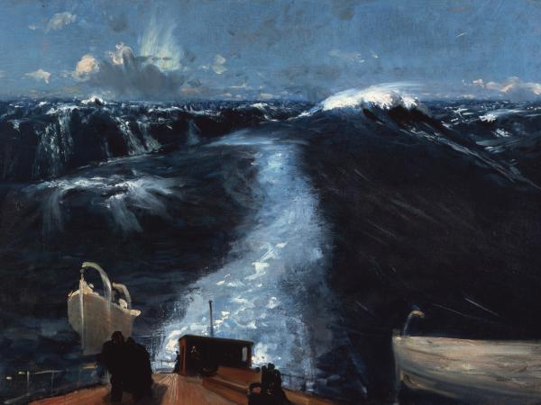 View of a large blue ocean wave from the perspective of a man on the dock of a ship.