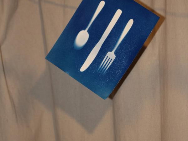 The sun print drying and hanging from a clothes hanger