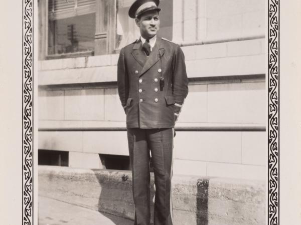 a man in a bell captain uniform outside the hotel