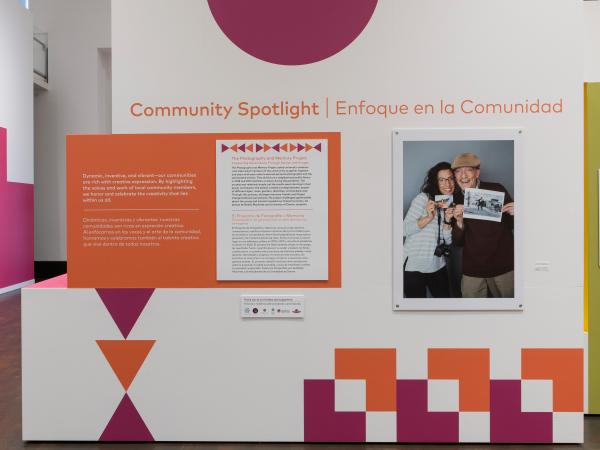 The introductory text and installation of the Community Spotlight photo exhibition