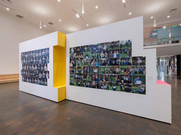 Installation view of a wall of photographs