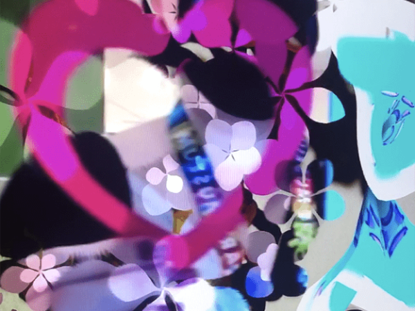 A paper heart shown through on the screen of the artwork "Secret Garden" by Daniel Brown