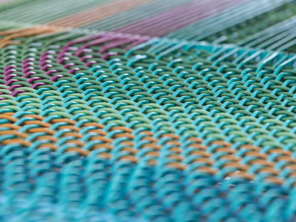 View of brightly colorful materials used in the La Musidora musical chairs installation